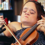 Mulher com doença óssea desafia limites e encontra nova maneira de tocar violino